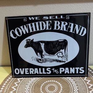 VTG Ande Rooney “We Sell Cowhide Brand Overalls & Pants” Metal Porcelain Sign
